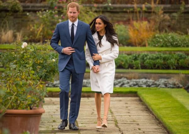For the official engagement photos, Meghan Markle stepped out in a luxurious white wrap coat by Line, a brand from her most recent adopted home of Canada. The coat sold out within minutes, has already been renamed the Meghan in her honour,  and will be back and available to buy from February. Dominic Lipinski/PA Wire