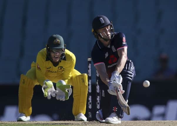 England's Chris Woakes plays a sweep in front of Australia's Tim Paine during their one-day international in Sydney on Sunday (Picture: Rick Rycroft/AP).