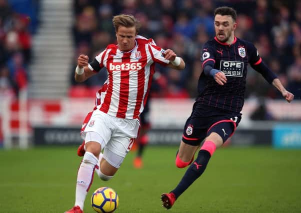 Huddersfield Town's Scott Malone moves in on Stoke City's Moritz Bauer during last Saturday's Premier League match at the bet365 Stadium (Picture: Nigel French/PA Wire).