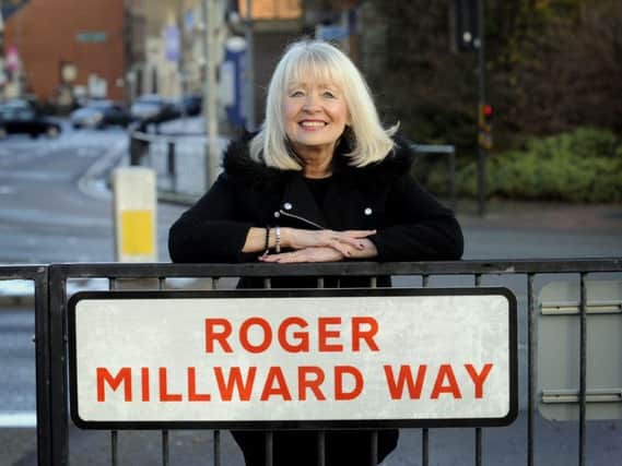 Carol Millward by one of the new signs that have gone up renaming Garrison Way in tribute to her late husband