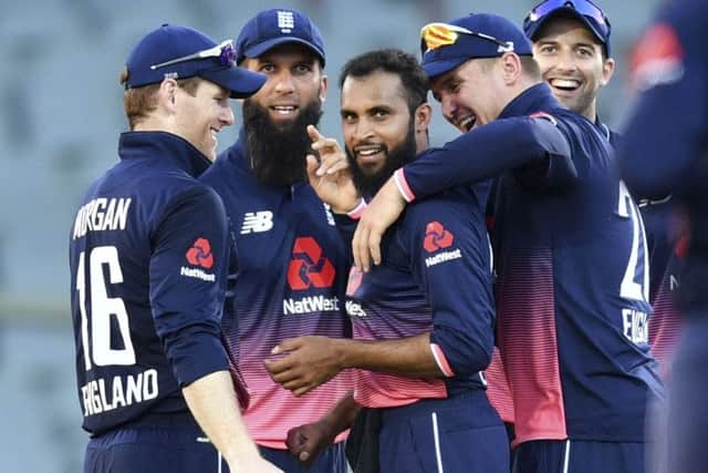 England's Adil Rashid celebrates with teammates after dismissing Australia's Mitchell Marsh in Adelaide. Picture: David Mariuz/AAP via AP