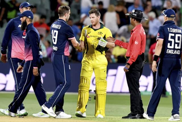 Australia's Tim Paine, center right, shakes hands with England's Chris Woakes, center left, at the end of the ODI in Adelaide. Picture: Sam Wundke/AAP via AP
