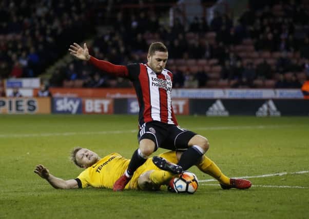 Fall guy: Tom Clarke  brings down Billy Sharp for a penalty.