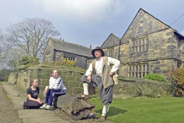 Gomersal Middle School  pupils Lucy Nield (left) and Hannah Walker, both aged 13,  take a close look at Kevin Walker of Dewsbury, who dressed as a 17th century looter for a historic storytelling session at Oakwell Hall, Birstall, yesterday (monday)