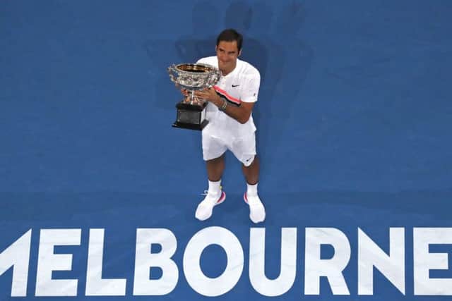 SwitzerlandÂ's Roger Federer holds his trophy after winning the Australian Open. Picture: AP/Ng Han Guan