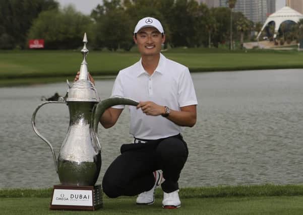 China's Li Haotong holds the trophy after he won the Dubai Desert Classic (Picture: Kamran Jebreili/AP).