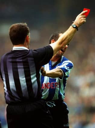 Seeing red: Sheffield Wednesday's Paolo Di Canio pushes out at referee Paul Alcock as he is shown the red card.