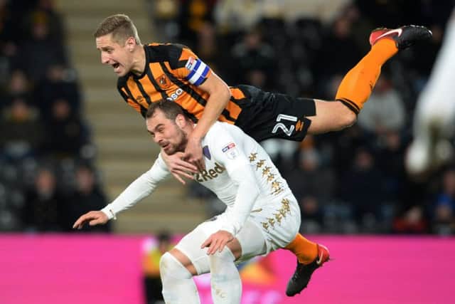 OVER THE TOP: Hull's Michael Dawson rides a challenge on Leeds' Pierre-Michael Lasogga at the KCOM Stadium.  Picture Bruce Rollinson