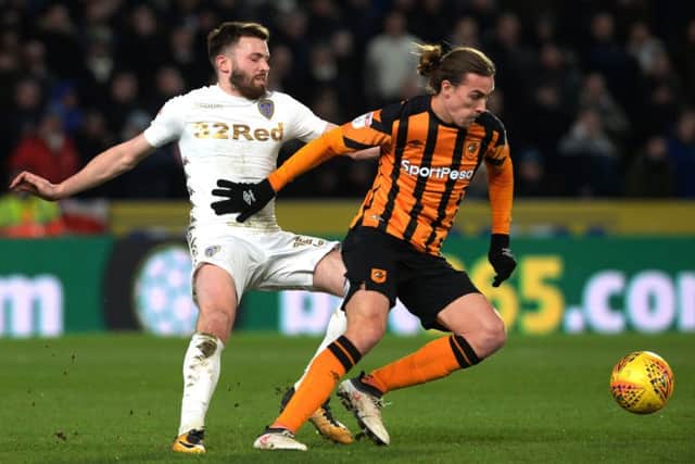 TIGHT NIGHT: Leeds' Stuart Dallas, left, is held off the ball by Hull's Jackson Irvine.  Picture: Bruce Rollinson
