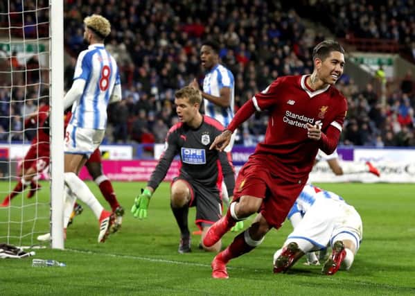 Liverpool's Roberto Firmino (right) celebrates scoring his side's second goal of the game against Huddersfield Town. Picture: Martin Rickett/PA