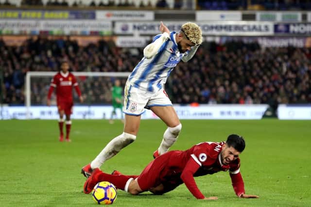 TROUBLE: Huddersfield Town's Philip Billing (left) fouls Liverpool's Emre Can (right) to give away a second-half  penalty. Picture: Martin Rickett/PA