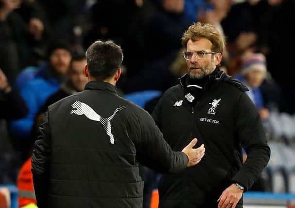 Liverpool manager Jurgen Klopp (right) and Huddersfield Town manager David Wagner (left) after the final whistle. Picture: Martin Rickett/PA