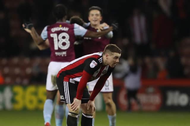 LATE BLOW: Sheffield United's John Fleck shows his disappointment as Aston Villa's players celebrate behind him. Picture: Simon Bellis/Sportimage