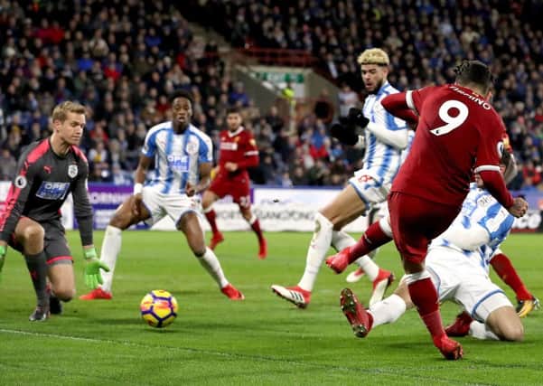 Liverpool's Roberto Firmino (right) scores his side's second goal of the game against Huddersfield. Picture: Martin Rickett/PA