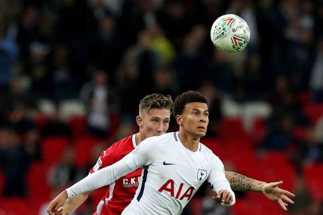 Barnsley's Angus MacDonald (left) playing against Tottenham Hotspur's Dele Alli (right) at Wembley in the Carabao Cup earlier this season (Picture: PA)