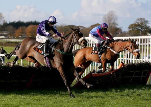 Lady Buttons and Adam Nicol (nearside) tackle La Bague Au Roi at Wetherby last year.