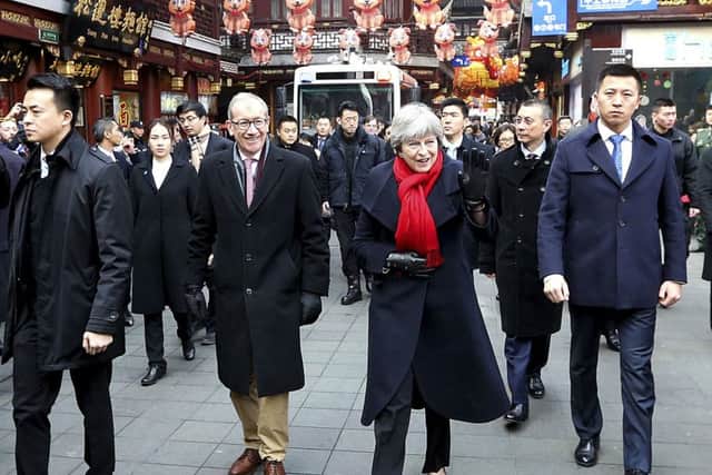 Theresa May and her husband Philip during a walkabout in Shanghai.