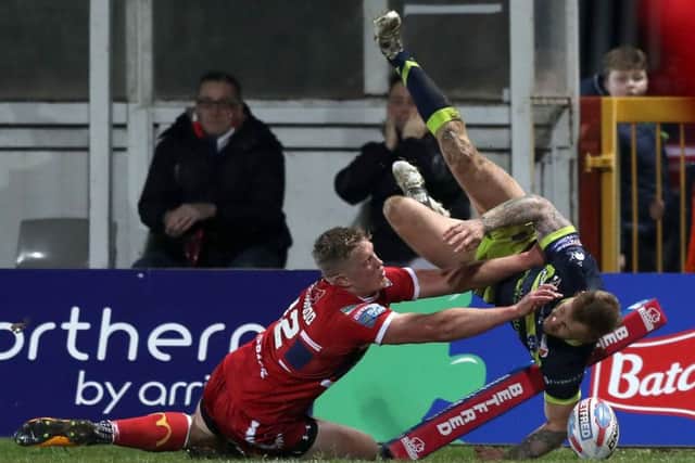 Wakefield Trinity's Tom Johnstone (right) dives in to score his side's first try.