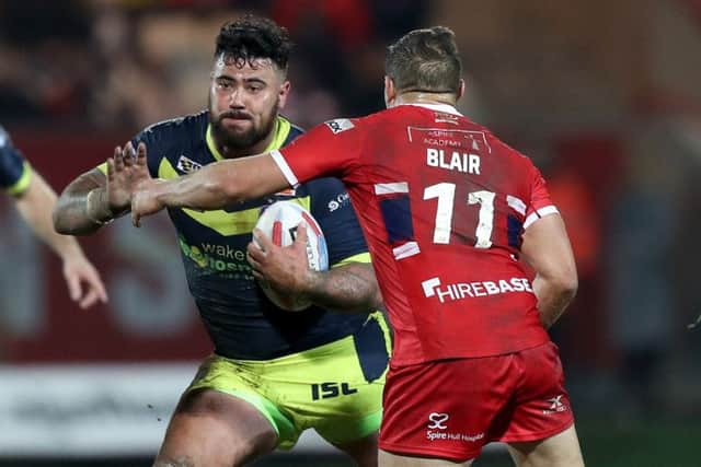 Wakefiekd Trinity's David Fifita (left) is tackled by Hull KR's Maurice Blair.