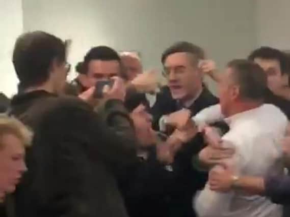 Handout still, taken with permission, from footage posted on the twitter feed of @chloekayex showing Tory MP Jacob Rees-Mogg being caught in the middle of a scuffle at the University of the West England, in Bristol.