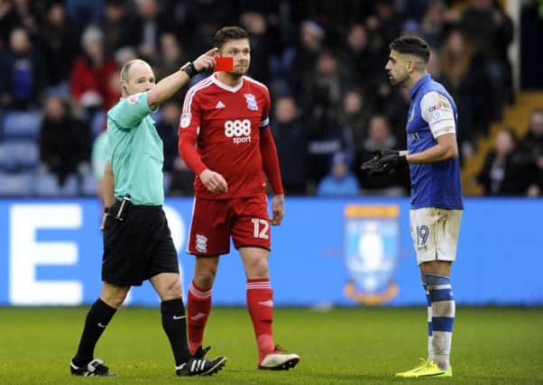 Referee Scott Duncan shows a red card to Owls' Marco Matias