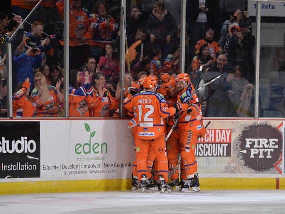 Mark Matheson (hidden) is mobbed baby his Sheffield Steelers team-mates after scoring the late game-winning goal against Nottingham Panthers. Picture: Dean Woolley.