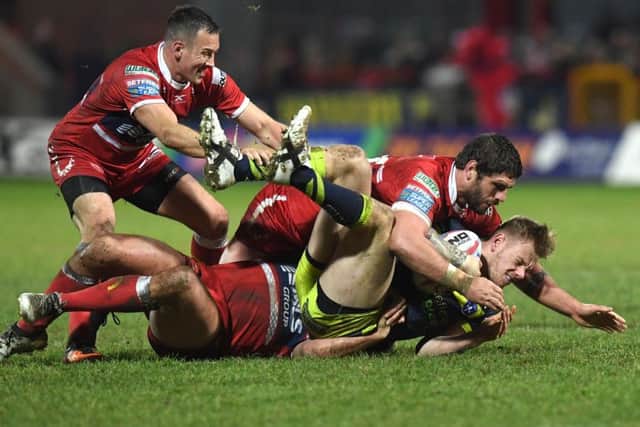 Tom Johnstone is tackled by Hull KR's Danny Maguire, Lee Jewitt and Chris Clarkson. PIC: Anna Gowthorpe/SWpix.com