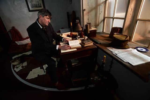 Poet Simon Armitage in a recreation of Branwell Bronte's bedroom at the Bronte Parsonage Museum