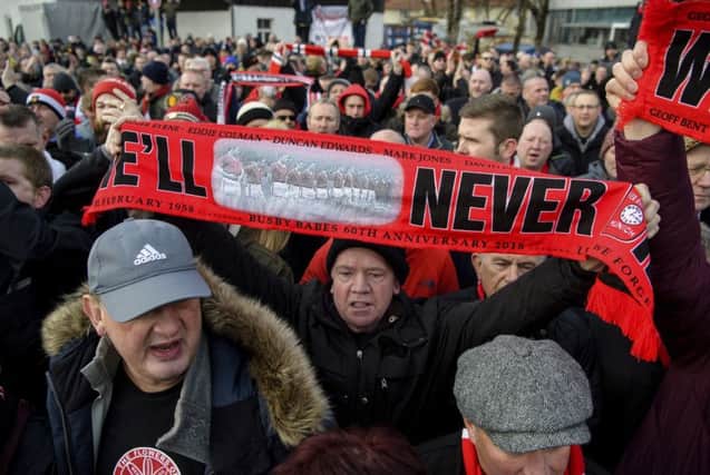 Soccer fans attend a commemoration ceremony on the Manchester place at the Munich Riem airport