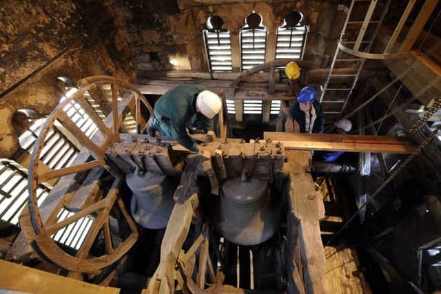 The bells are painstakingly removed from the tower. Picture: John Giles/PA Wire