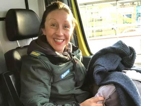Paramedic Leilah Nolan with clothes to give to a homeless patient.