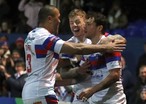 Wakefield Trinity's  Scott Grix (right) celebrates scoring his side's first try.