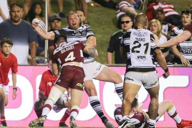 Hull FC's Danny Washbrook is pushed out of bounds by Wigan's Oliver Gildart.