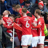 Oli McBurnie runs towards Barnsley supporters to celebrate his equaliser against Sheffield Wednesday at Oakwell on Saturday (Picture: Steve Ellis).