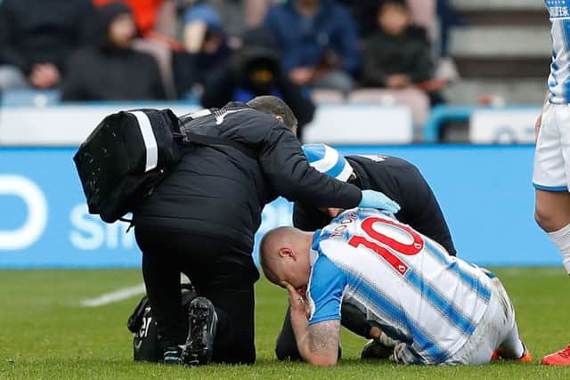 Huddersfield Town were relieved to learn that Aaron Mooys injury, which forced him to be stretchered off against Bournemouth, is not as serious as it first appeared (Picture: Martin Rickett/PA Wire).