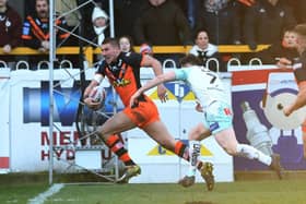 Castleford's Greg Minikin gets away from Widnes' Thomas Gilmore to score the opening try.