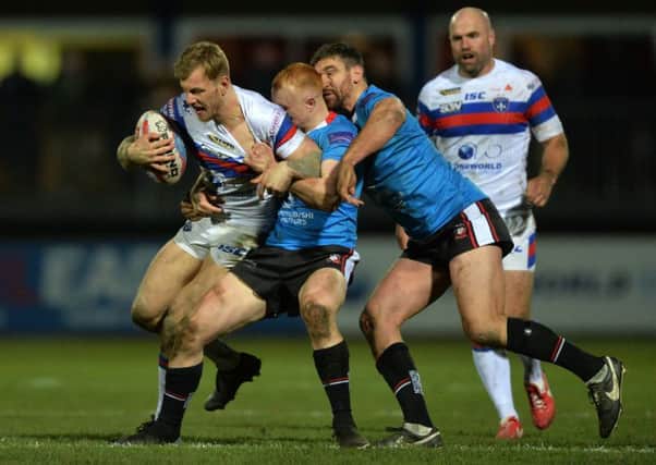 Tom Johnstone is stopped by Josh Wood.