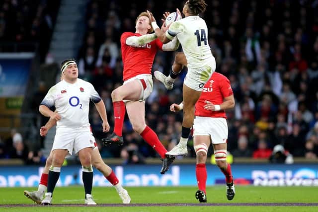 Wales' Rhys Patchell (centre left) and England's Anthony Watson (right) in action.