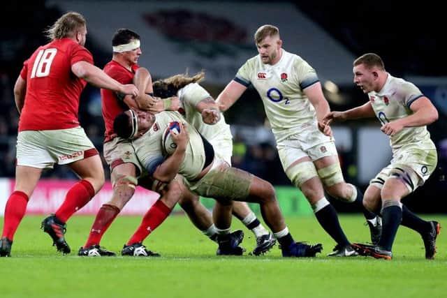 England's Mako Vunipola (centre) takes on the Wales.