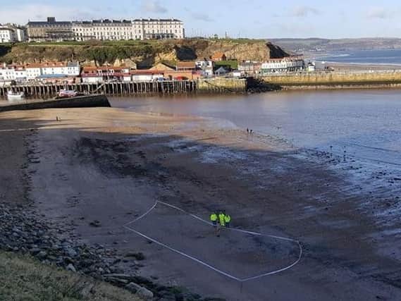A section of Whitby beach was cordoned off to investigate a suspected explosive device. Picture by Whitby Coastguard.