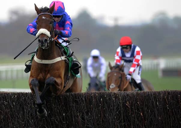 Cue Card and Paddy Brennan clear the last in the 2015 Charlie Hall Chase at Wetherby.
