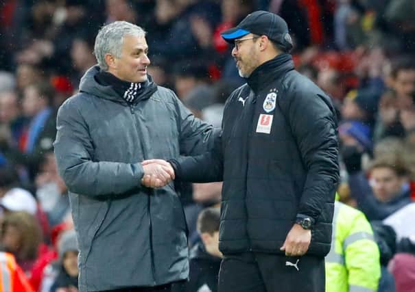 Manchester United manager Jose Mourinho, left, and Huddersfield Town manager David Wagner shake hands after the Red Devils' 2-0 victory at Old Trafford a fortnight ago (Picture: Martin Rickett/PA Wire).