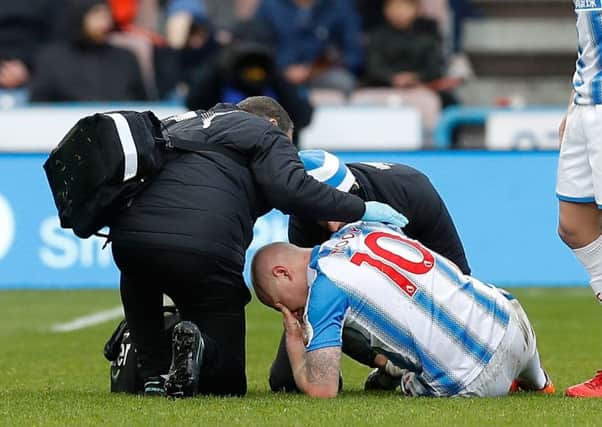 Huddersfield Towns Aaron Moy was stretchered off last week against Bournemouth with a knee injury. It proved to be only a cut but a subsequent infection has sidelined him (Picture: Martin Rickett/PA Wire).