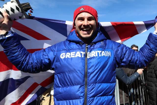 Great Britain's Dom Parsons celebrates getting a bronze medal in the Men's Skeleton