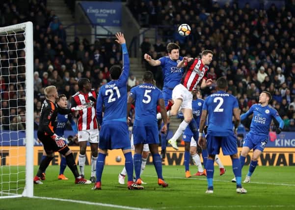 Leicester Citys Harry Maguire, top left, and Sheffield Uniteds Chris Basham in aerial combat (Picture: Martin Rickett/PA Wire).
