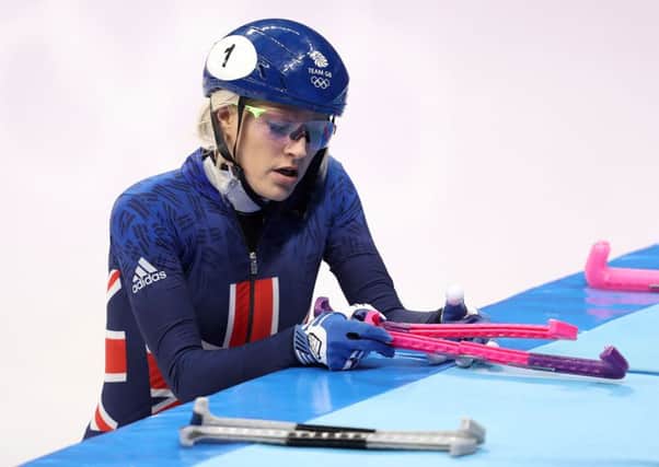 Downhearted: Elise Christie prepares to leave the ice.