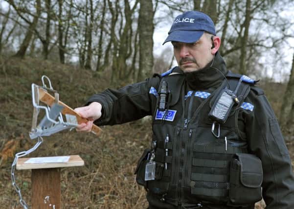 PCSO Bryan Tongue demonstrates how pole traps work