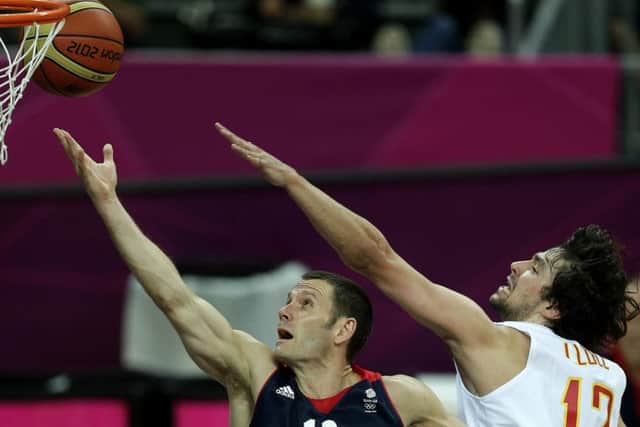 Britain's Nate Reinking, left, puts up a shot under pressure from Spain's Sergio Llull during a men's basketball game at the 2012 Summer Olympics (AP Photo/Charlie Riedel)