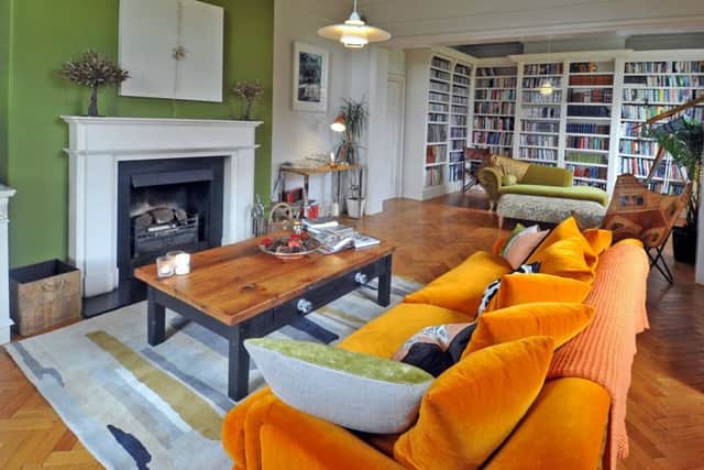 The former dining room and separate snug have been combined to make a large library with bespoke bookshelves and sofa from Loaf