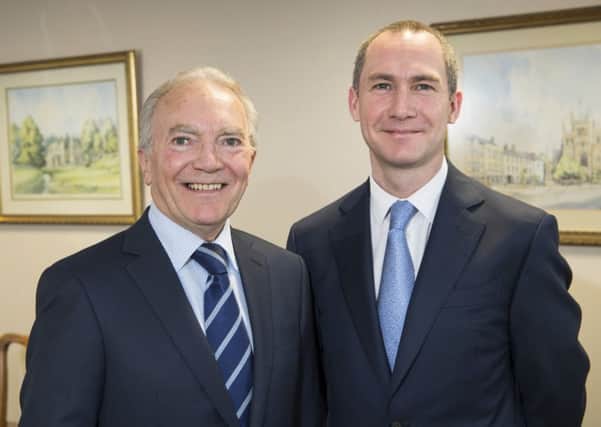 Tim Garnett, former managing director of The Ogden Group of Companies, with his son Justin, who is taking on the role